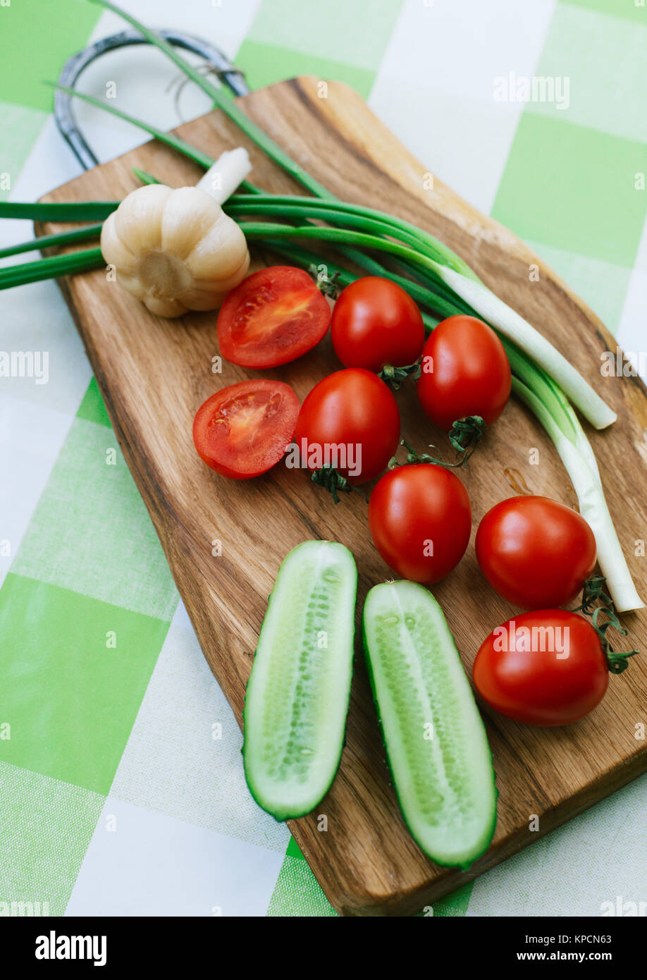 tomatoes and green onions on cutting board Stock Photo - Alamy