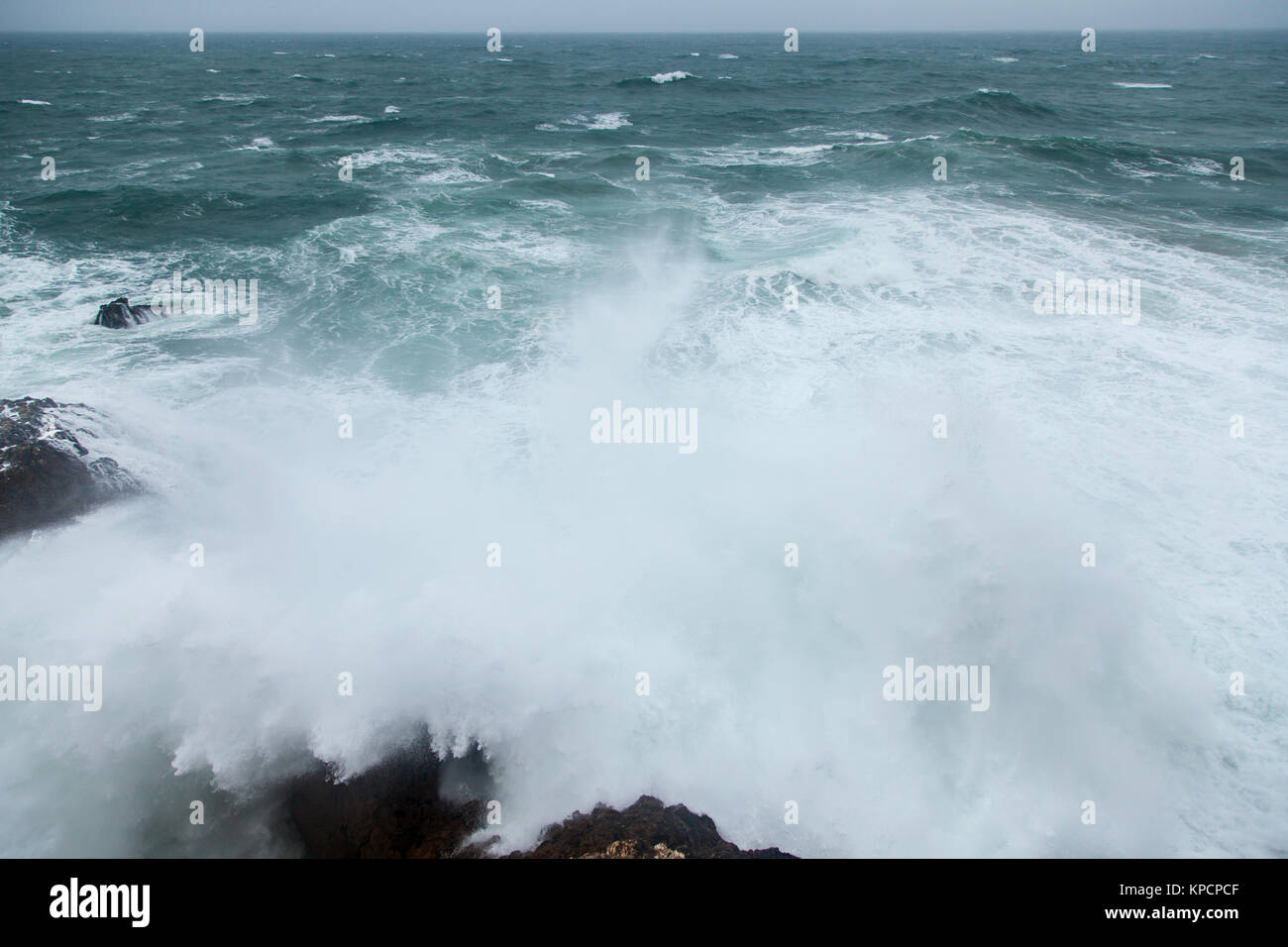 storm waves splashing on rocks Stock Photo