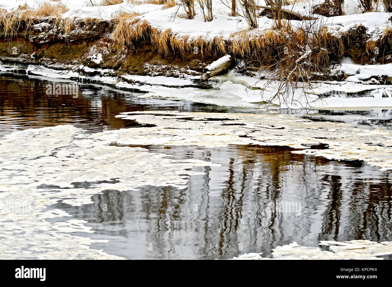 Ice in water and snow on the shore Stock Photo - Alamy