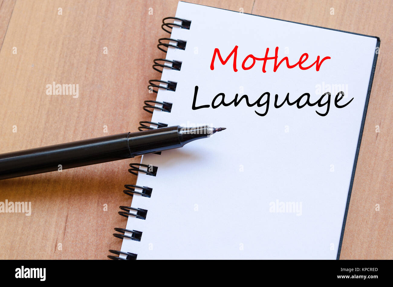 Mother language write on notebook Stock Photo