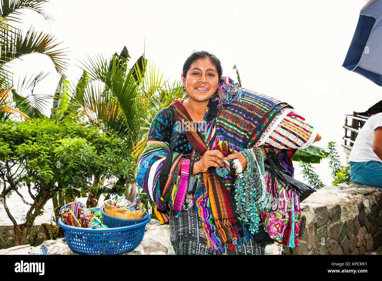 PANAJACHEL, GUATEMALA-DEC 24, 2015: : Guatamalian woman salling traditional  colorful fabric at the street market  in Panajachel, on Dec 24, 2015, Gua Stock Photo