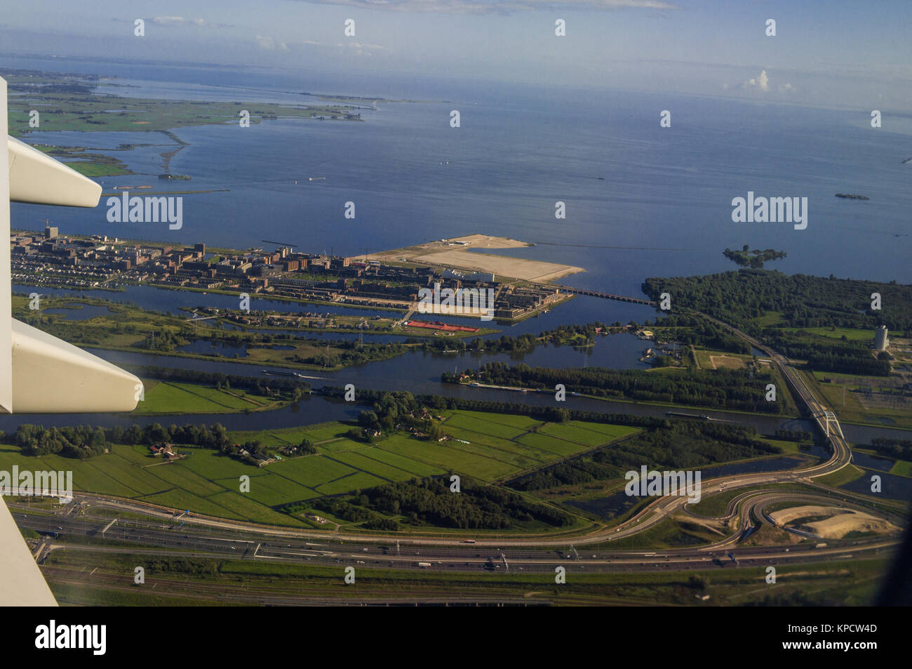 Cargo Harbour Aerial View from Jet Aircraft Porthole Stock Photo