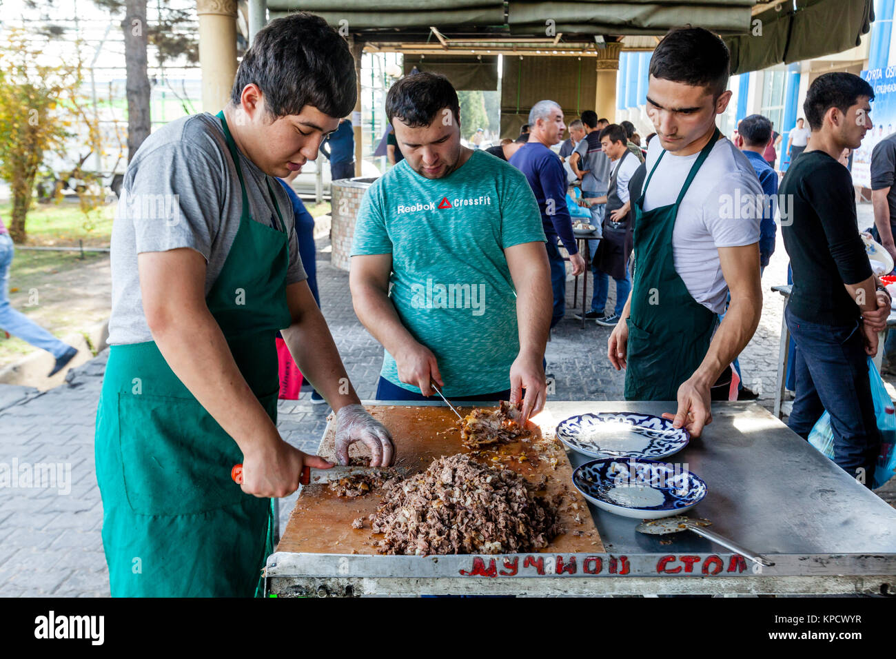 Cooks Carving Up Meat At The Central Asian Plov Centre, Tashkent, Uzbekistan Stock Photo
