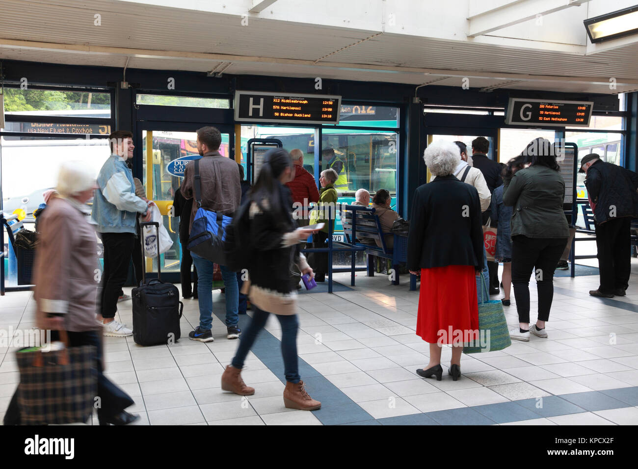 Passengers waiting for buses in North Road bus station, Durham, England Stock Photo