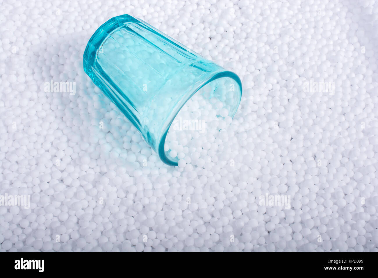Empty glass on little white polystyrene foam balls Stock Photo - Alamy