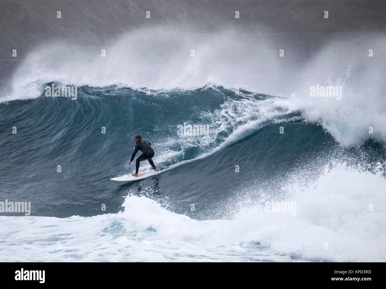 Surfer riding a huge wave at El Confital, Las Palmas, Gran Canaria ...