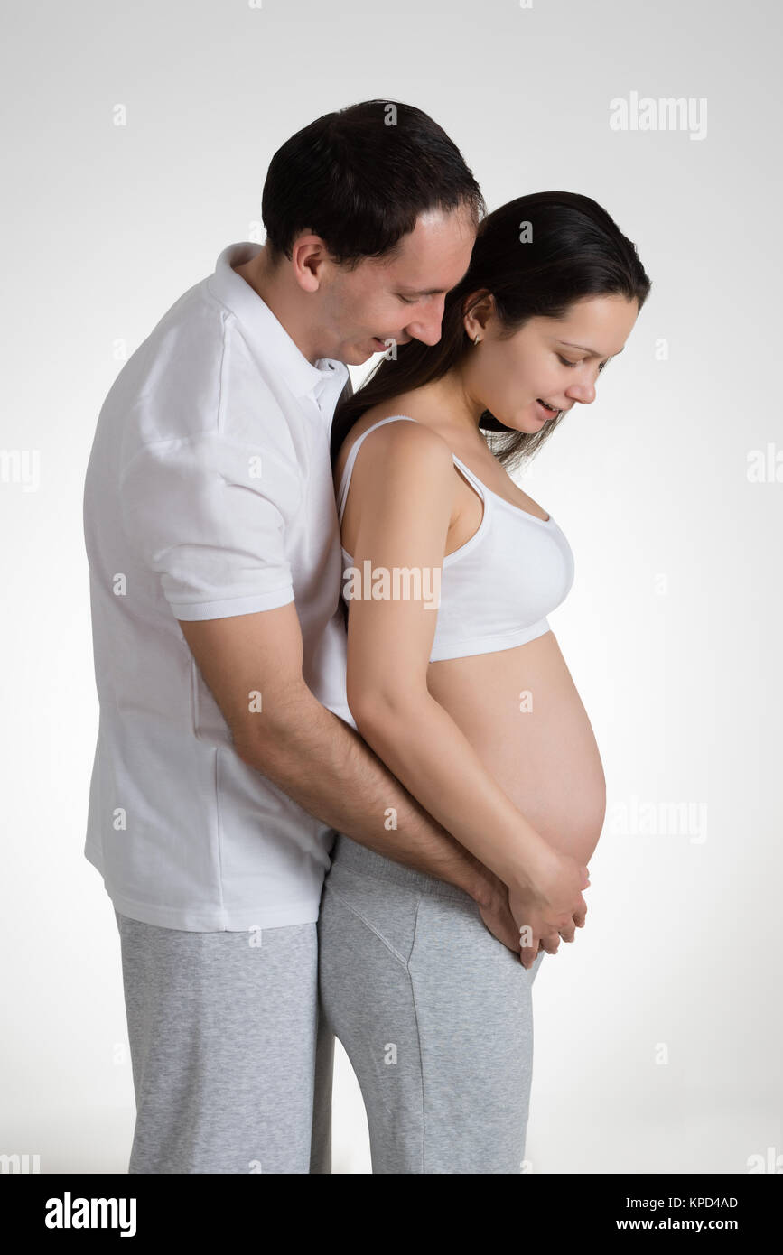 Man Embracing Pregnant Woman Stock Photo - Alamy