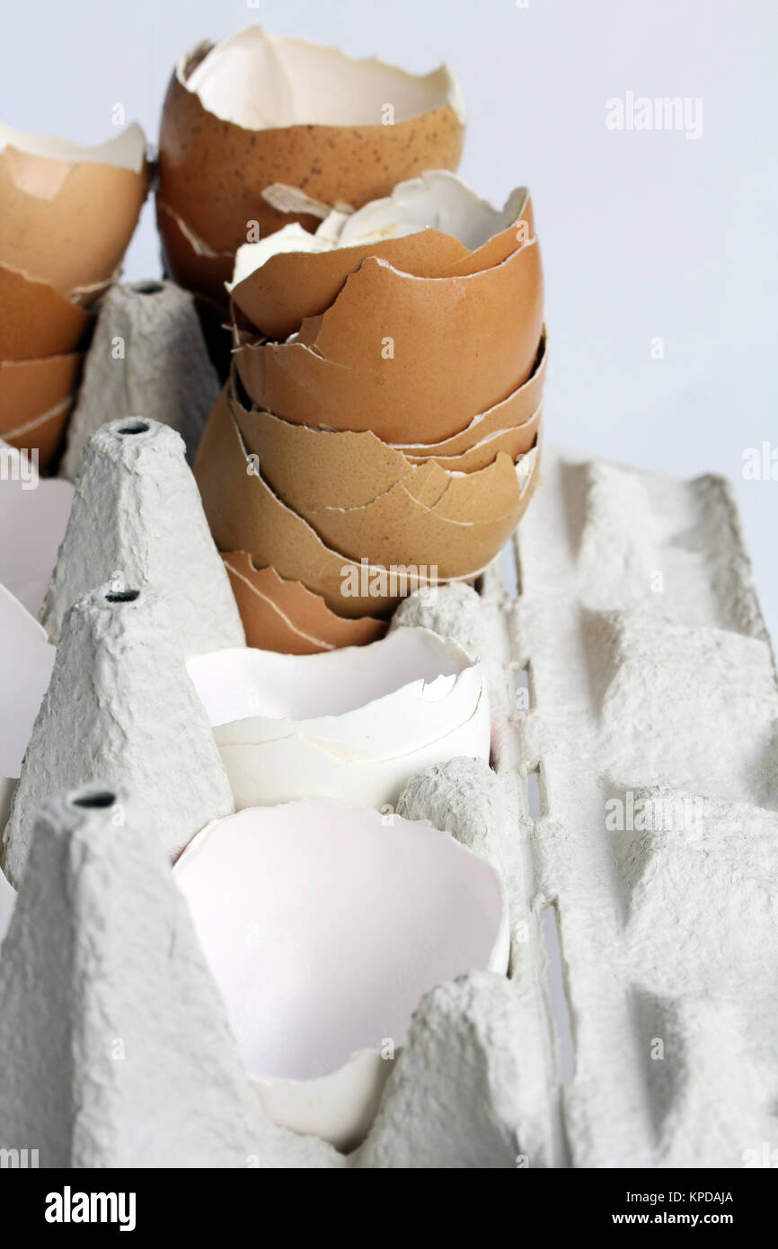 empty eggshells in an egg carton - a lot of brown and white egg shells Stock Photo