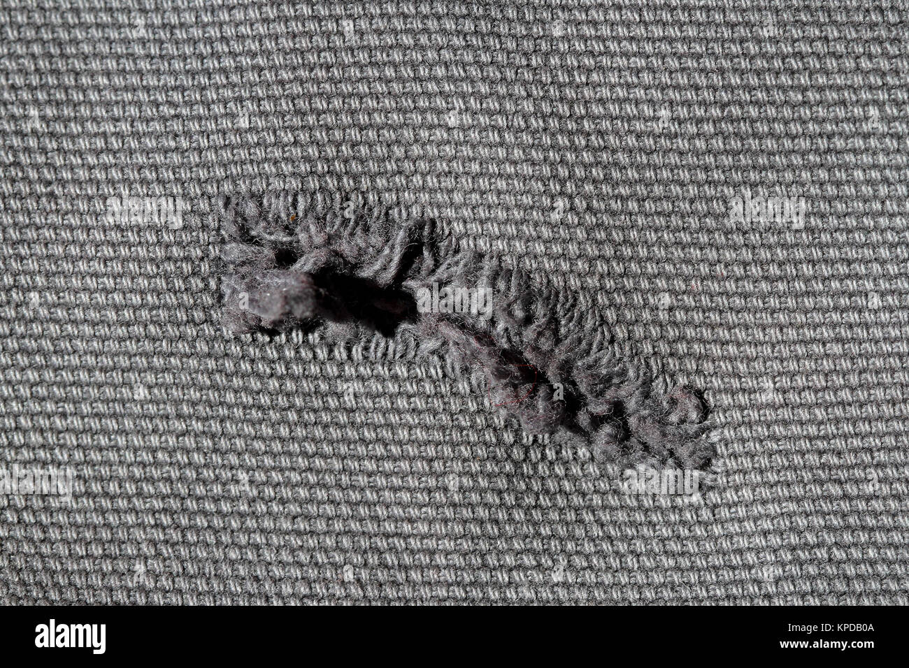 Hole in Textile Stock Photo - Alamy