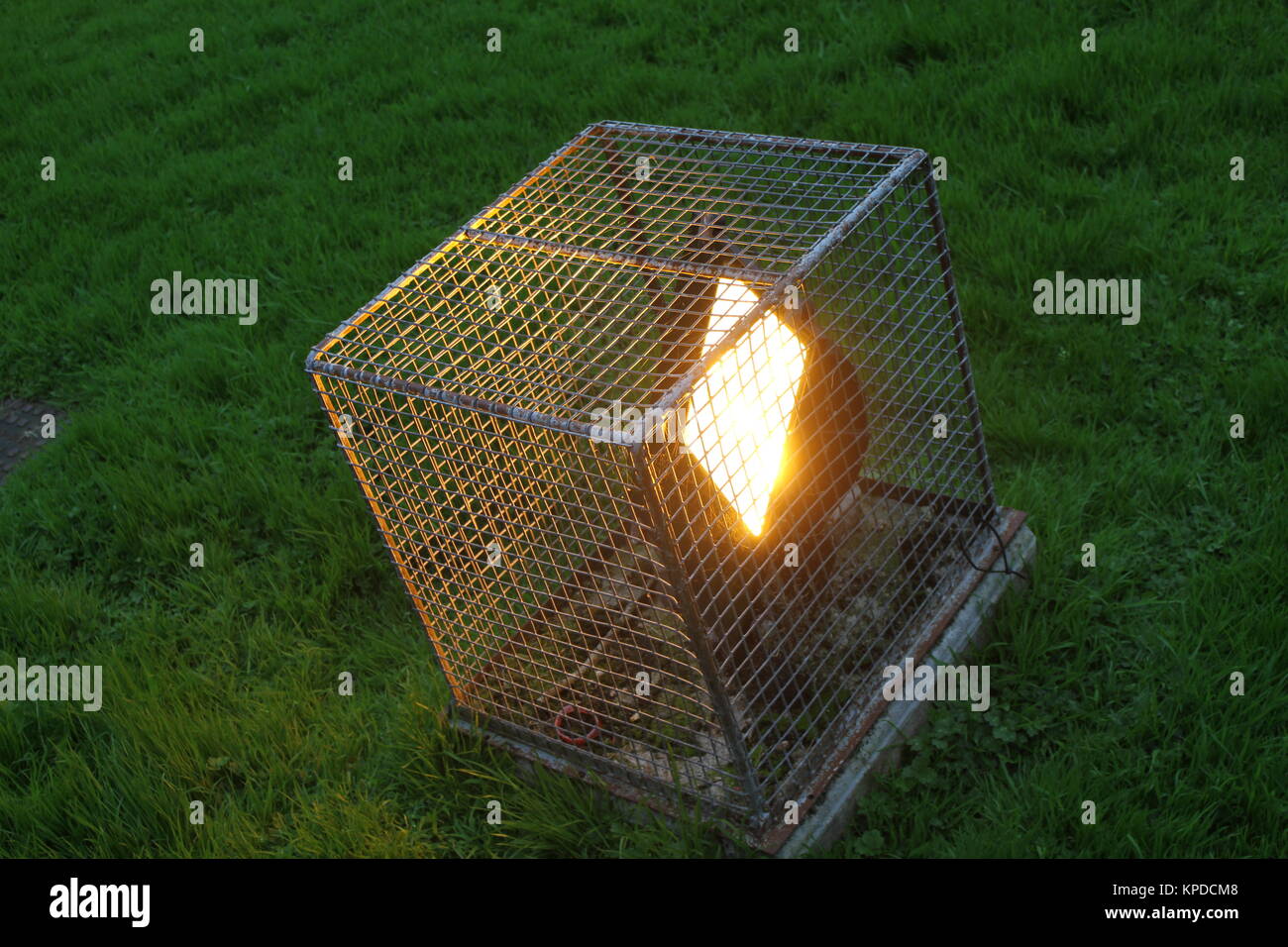 A floodlight in a wire cage Stock Photo