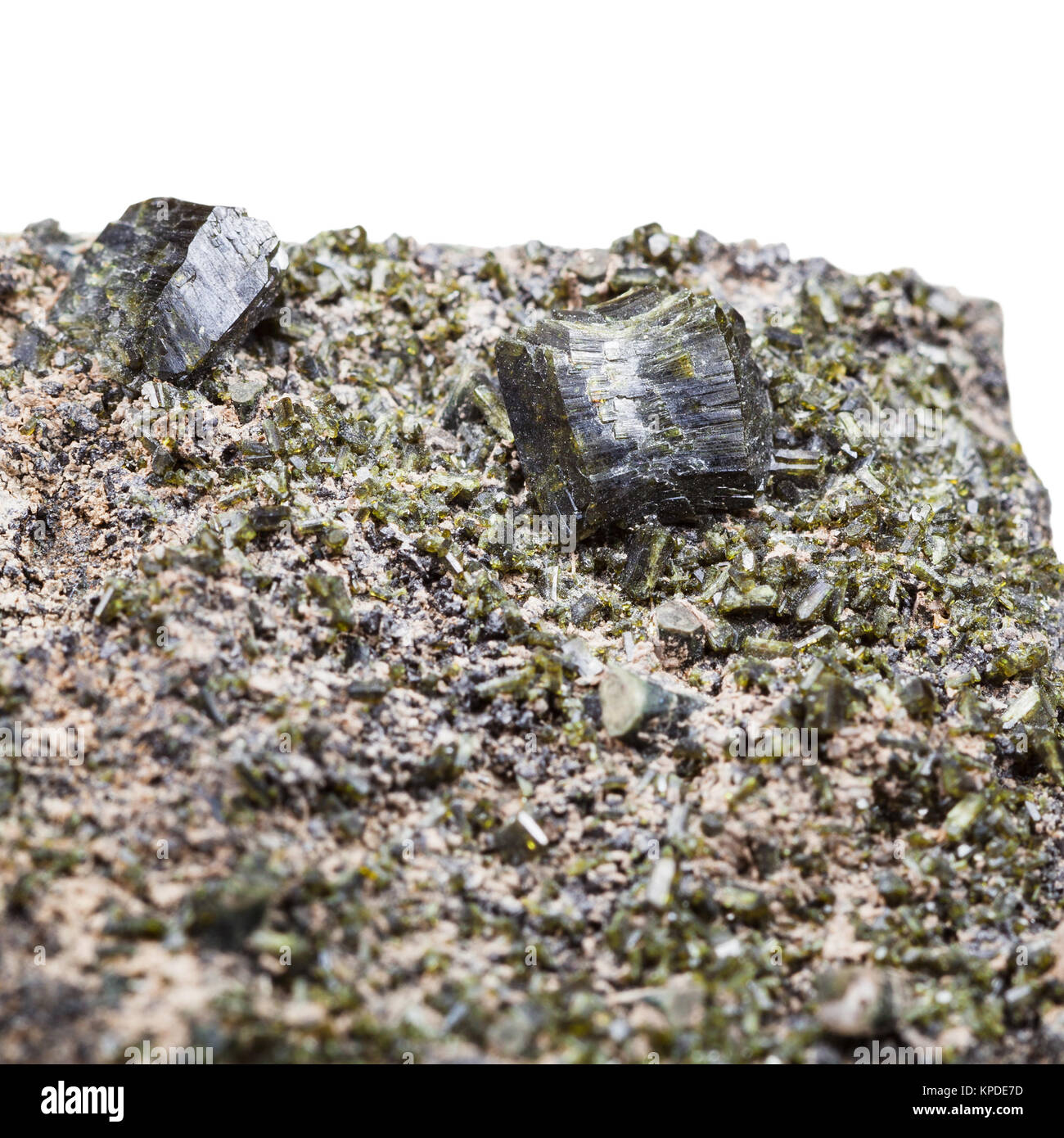 druse of green epidote crystals close up on rock Stock Photo