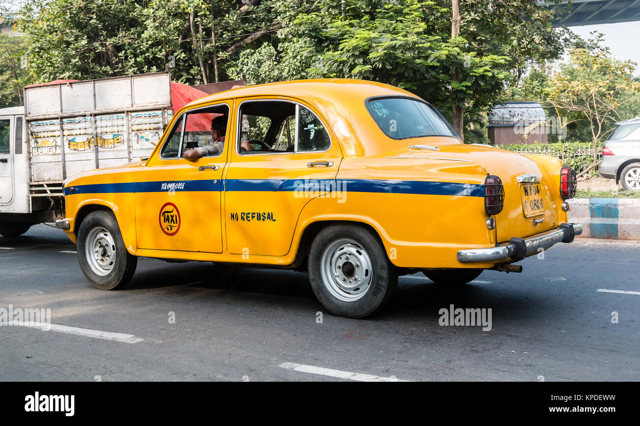 Iconic yellow indian taxi in Calcutta.  The Ambassador tax vehicle is no longer being built. Stock Photo