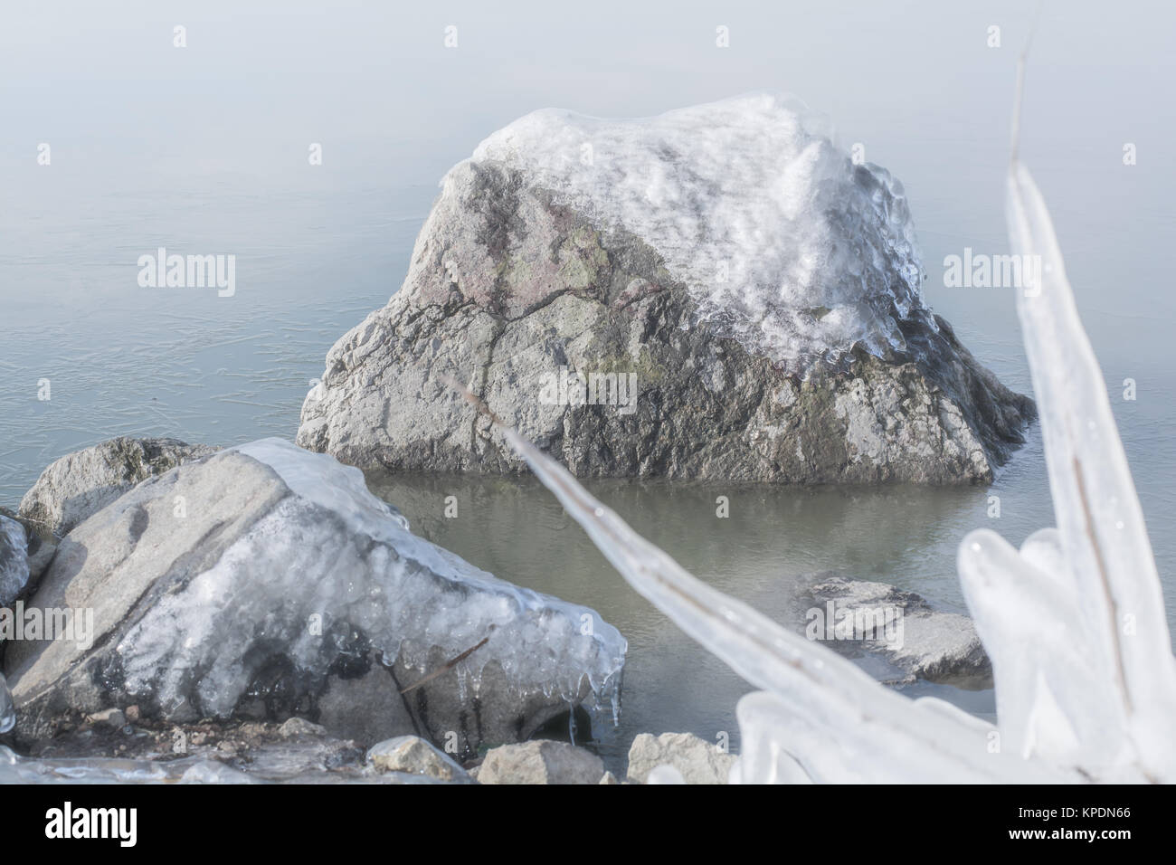 Frozen rocks with ice in the winter lake Stock Photo - Alamy