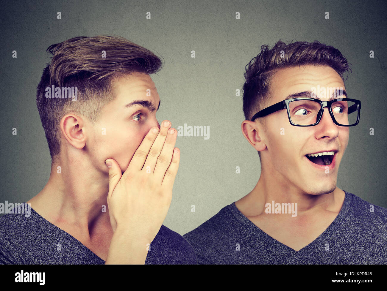 Latest rumors. Secretive man whispering in the ear to surprised himself Stock Photo