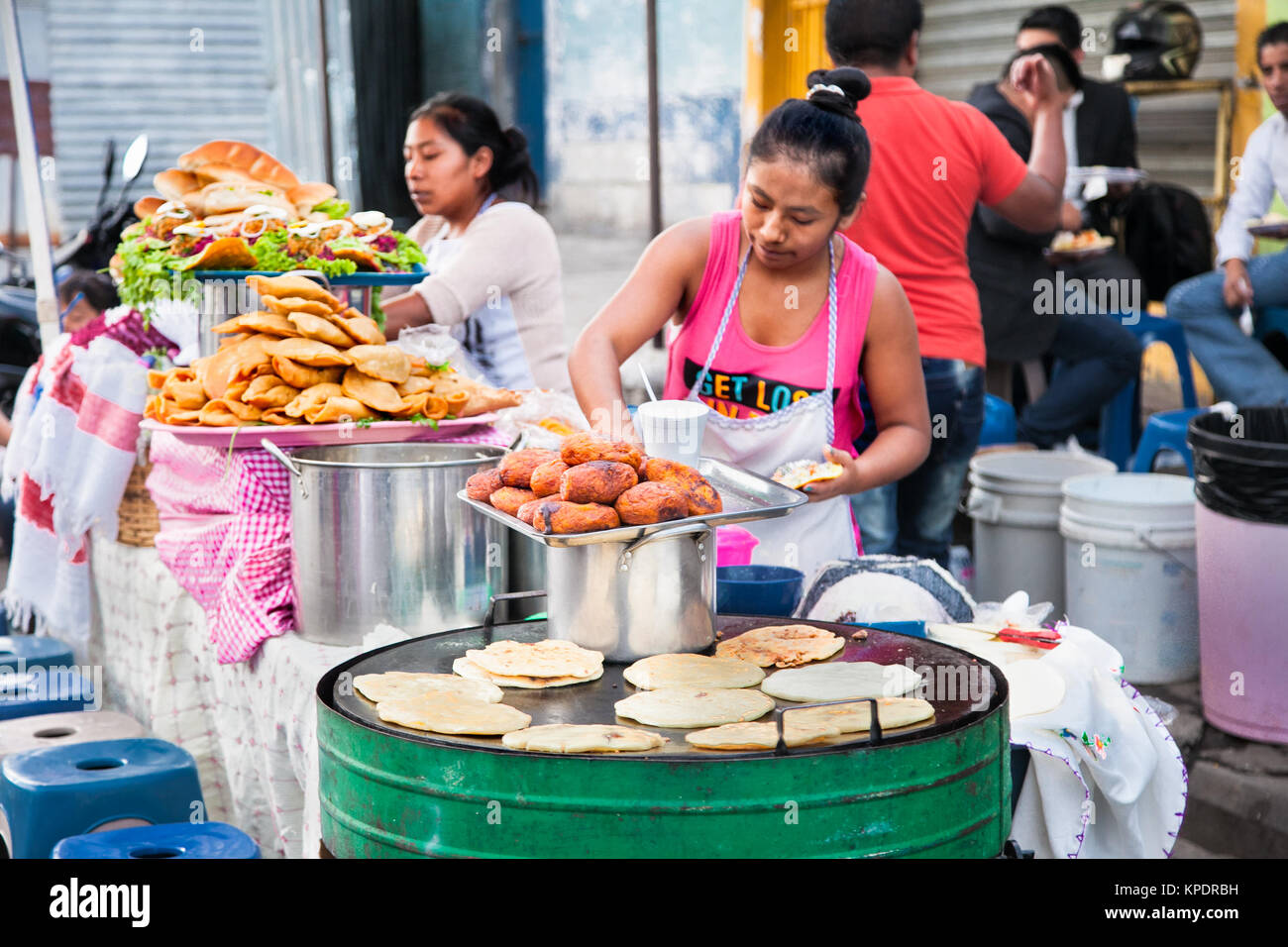 GUATEMALA CITY, GUATEMALA-DEC 25, 2015: Mayan women sell a  Guatemalan food  at the street of Guatemala city on Dec 25 2015. Guatemala. Stock Photo