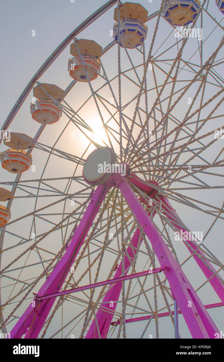 Ferris wheel with the sun behind it shining through. Stock Photo