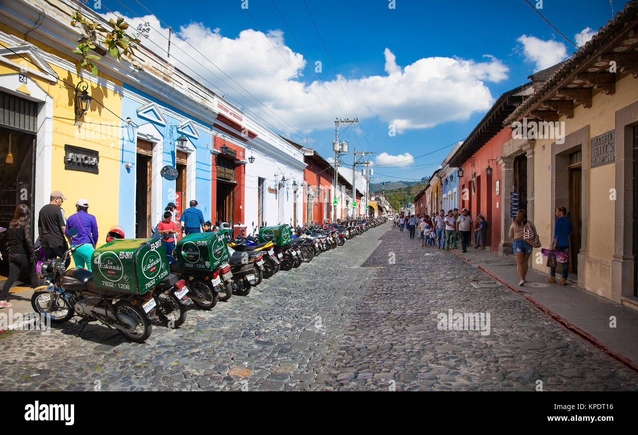 ANTIGUA, GUATEMALA-DEC 27, 2015: Main street with local people and colonial houses in Antigua on Dec 27, 2015. Guatemala.  The historic city Antigua i Stock Photo