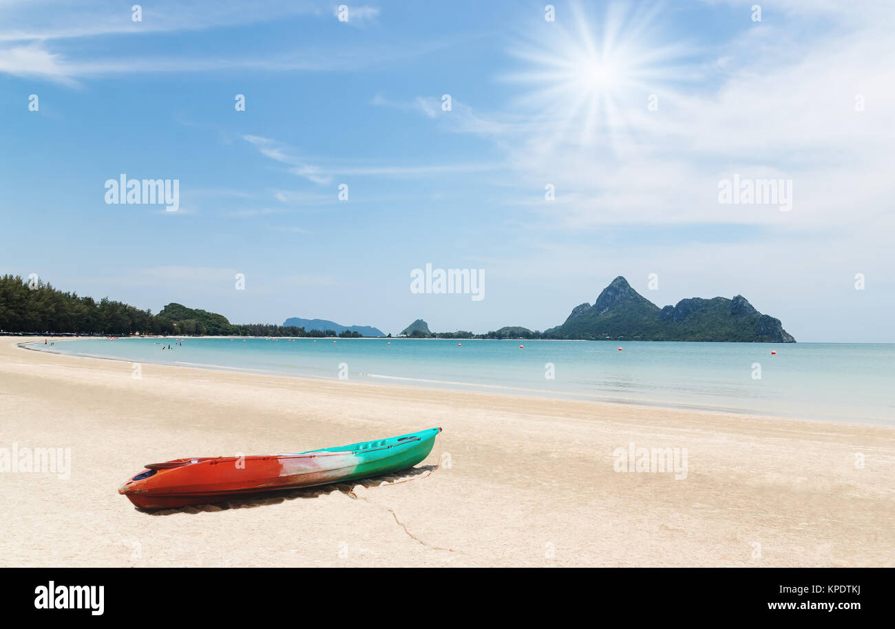 Beach with over sunlight and boat Stock Photo - Alamy