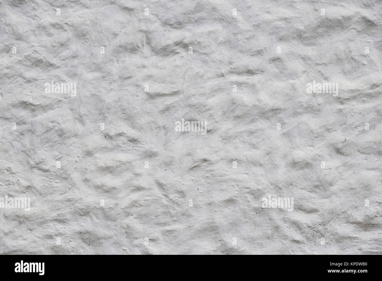 White wall of embossed decorative plaster Stock Photo
