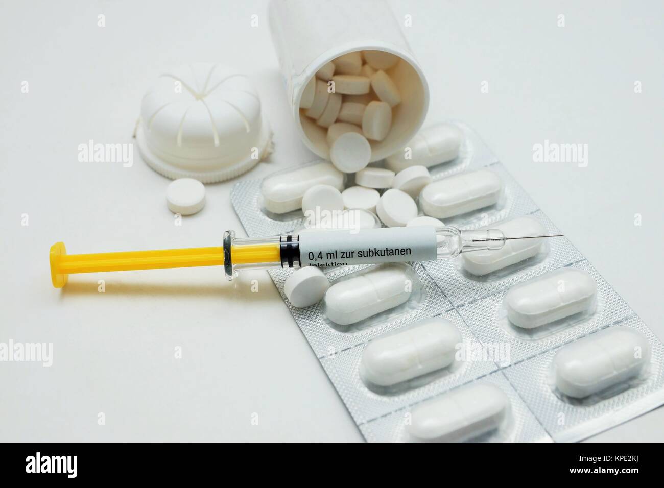 syringe and tablets on white background Stock Photo