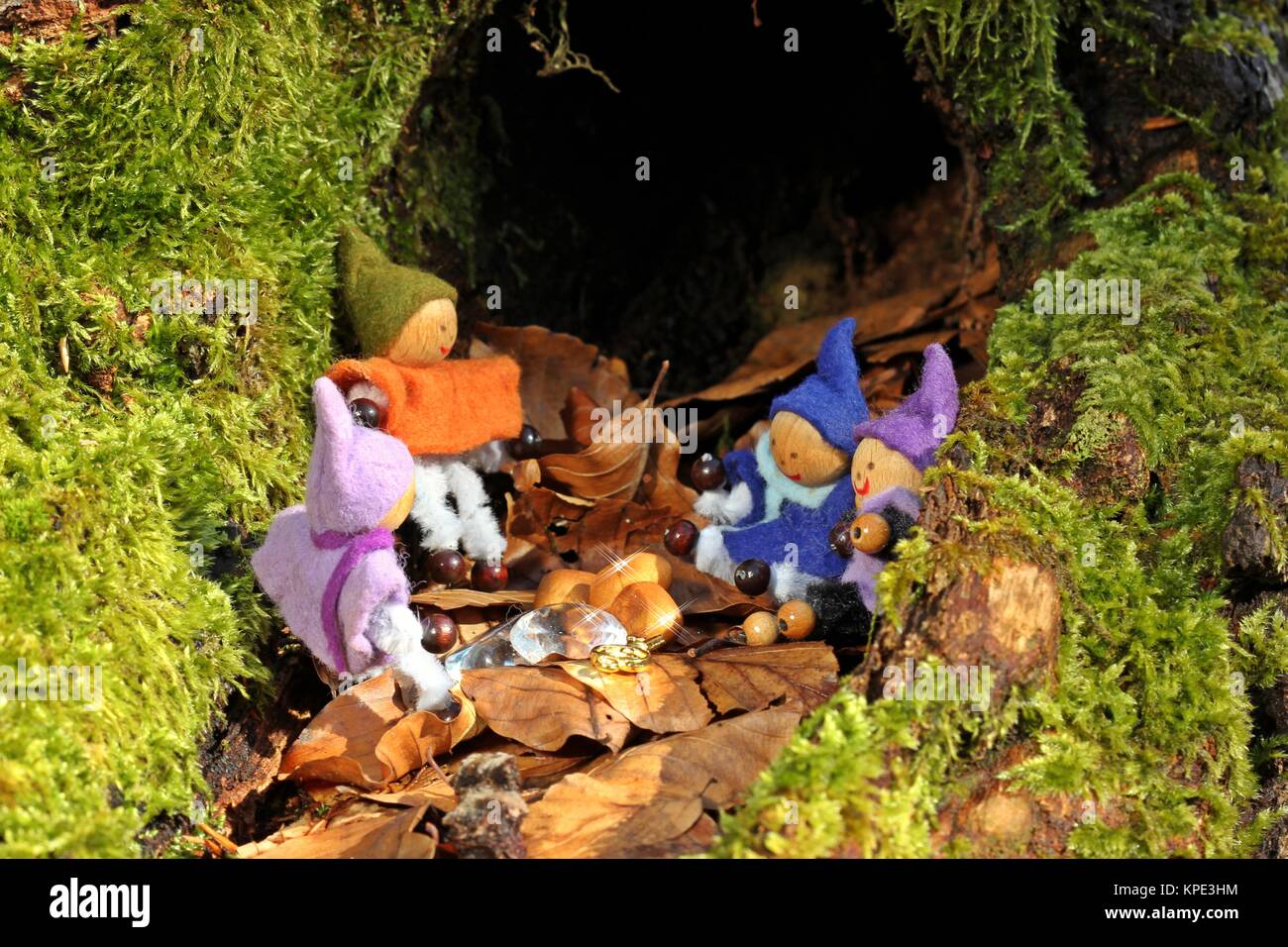 Four little gnomes find a treasure Stock Photo