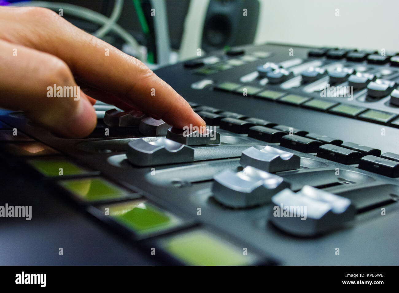 hand on a light, mixing desk fader in blur television gallery Stock Photo