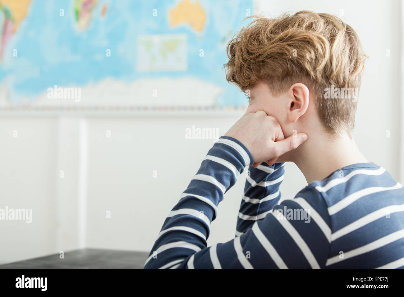 Bored Boy Sitting at Desk Head in Hands Stock Photo Alamy