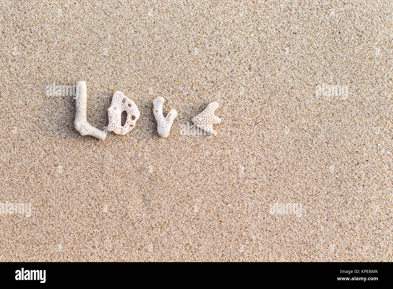 Love inscription made of shells on white sand Stock Photo - Alamy