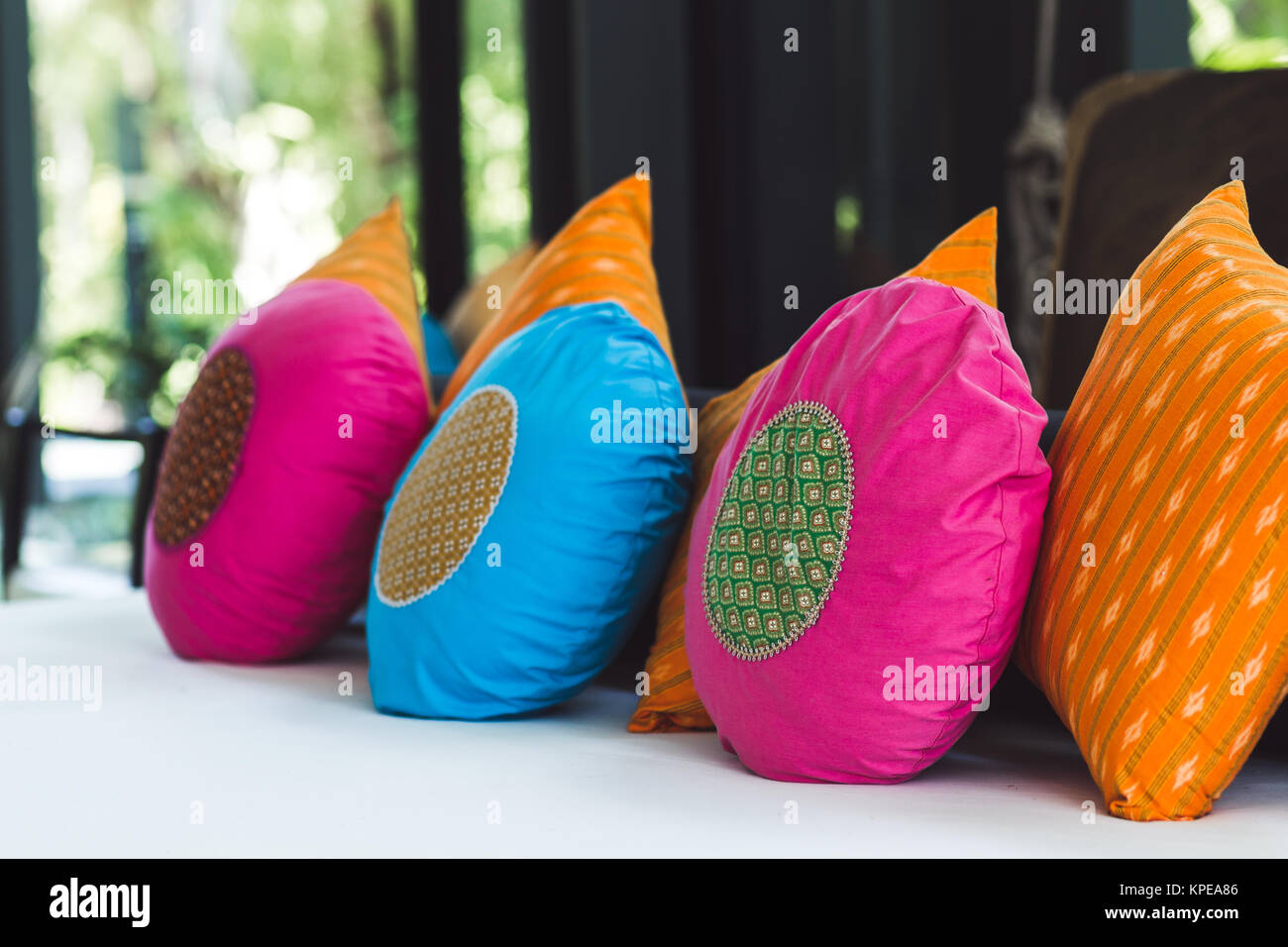 Multicolor round pillows on sofa Stock Photo Alamy