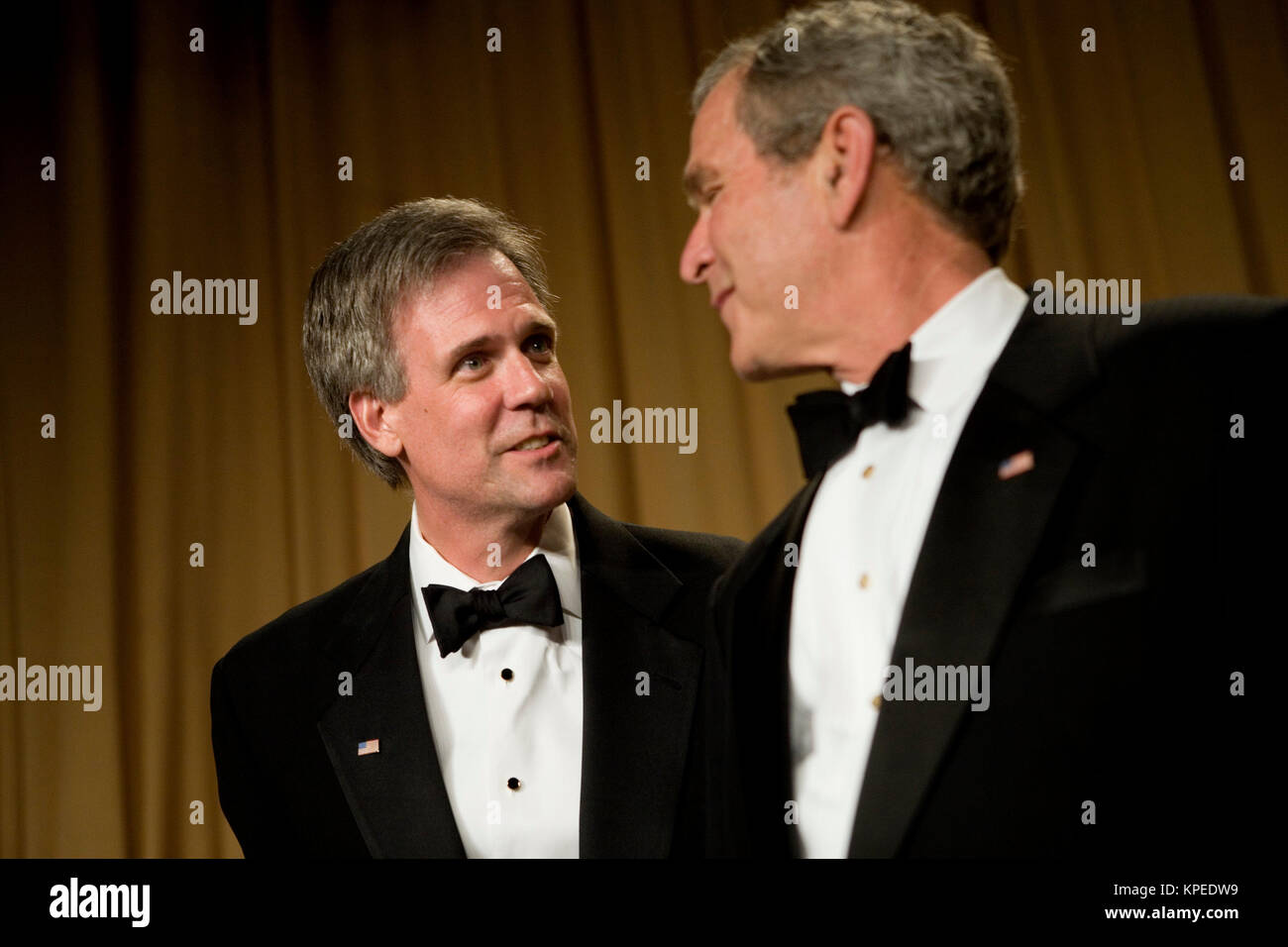 Washington, D.C. - April 21, 2007 - United States President George W Bush (R) looks to his spokesperson Tony Snow (L), who has been out since cancer was discovered during a surgery, at the White House Correspondents Association Dinner April 21, 2007 in Washington, DC.  Comedian Rich Little hosted and provided entertainment for President George W Bush, White House reporters, their guests and celebrities.  Credit: Brendan Smialowski - Pool via CNP /MediaPunch Stock Photo