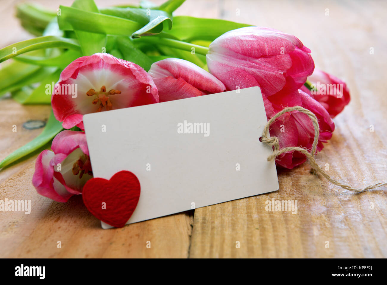 Pink tulip bouquet and blank greeting card. Pink tulips with card on ...