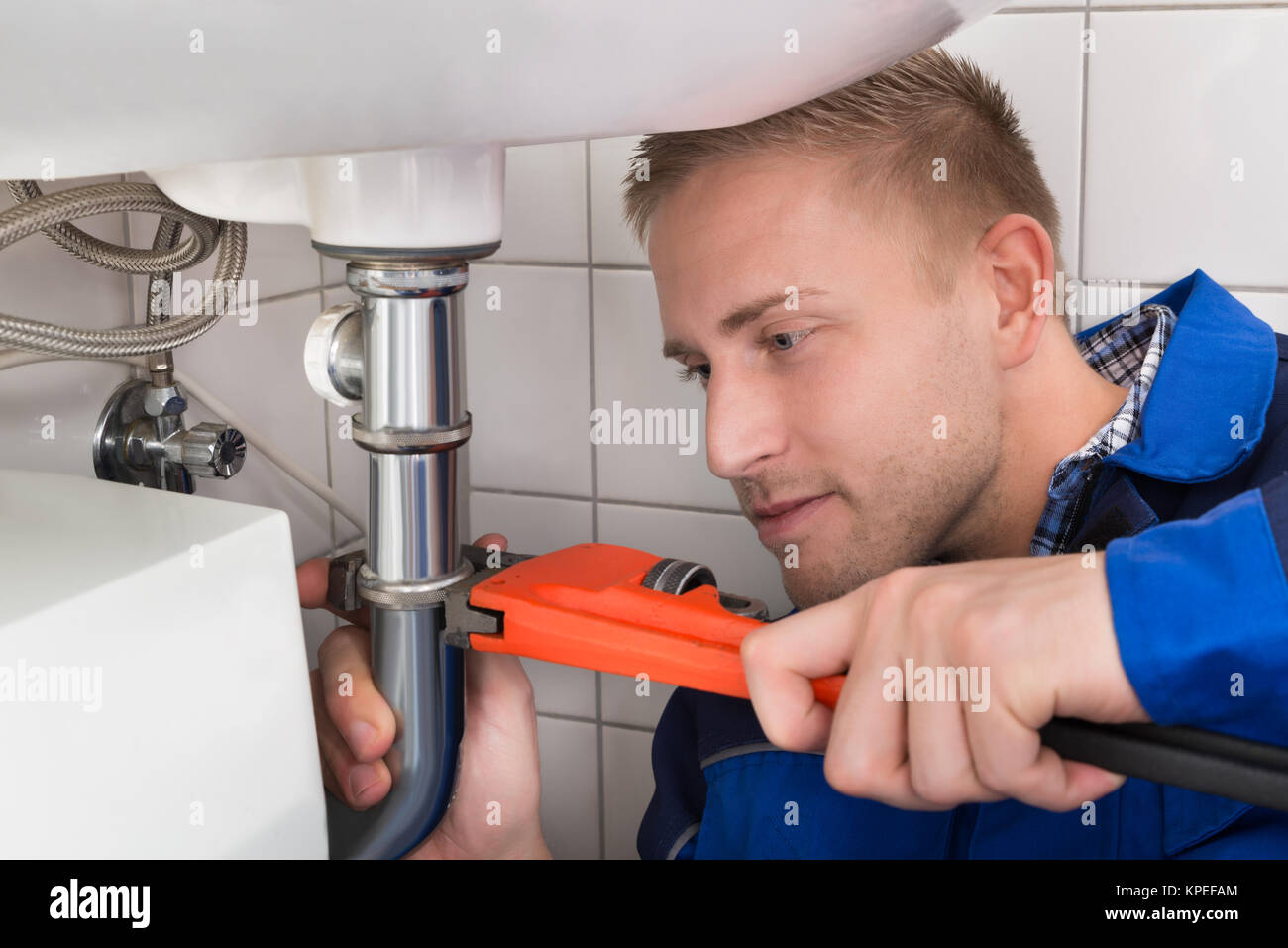 Male Plumber Fixing Sink In Kitchen Stock Photo Alamy
