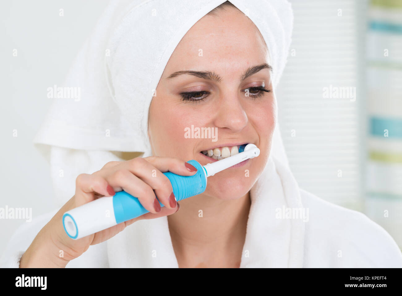 Woman Brushing Teeth With Electric Toothbrush Stock Photo Alamy