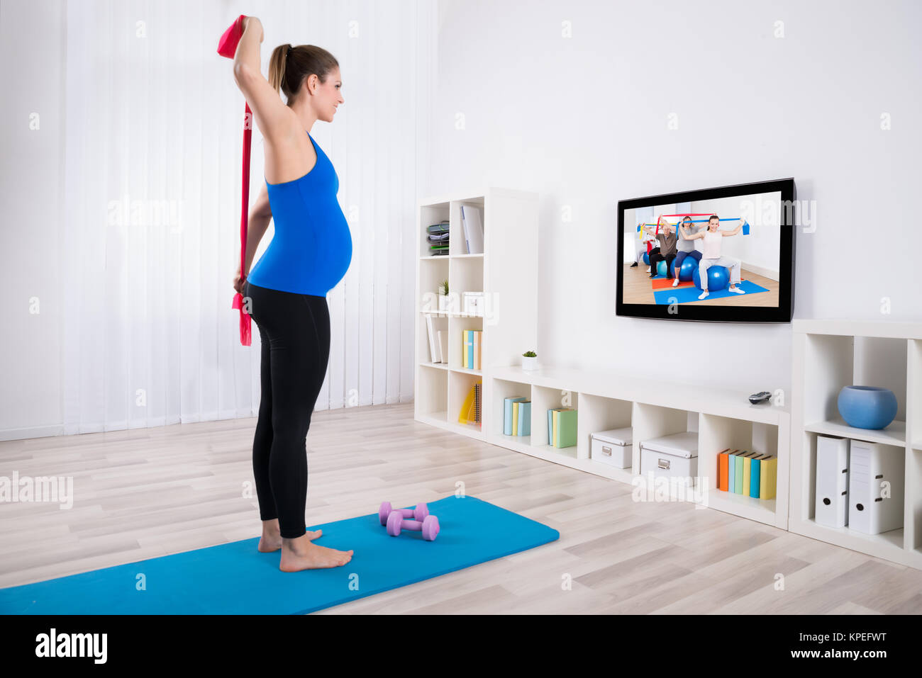 Pregnant Woman Watching Television Stock Photo - Alamy
