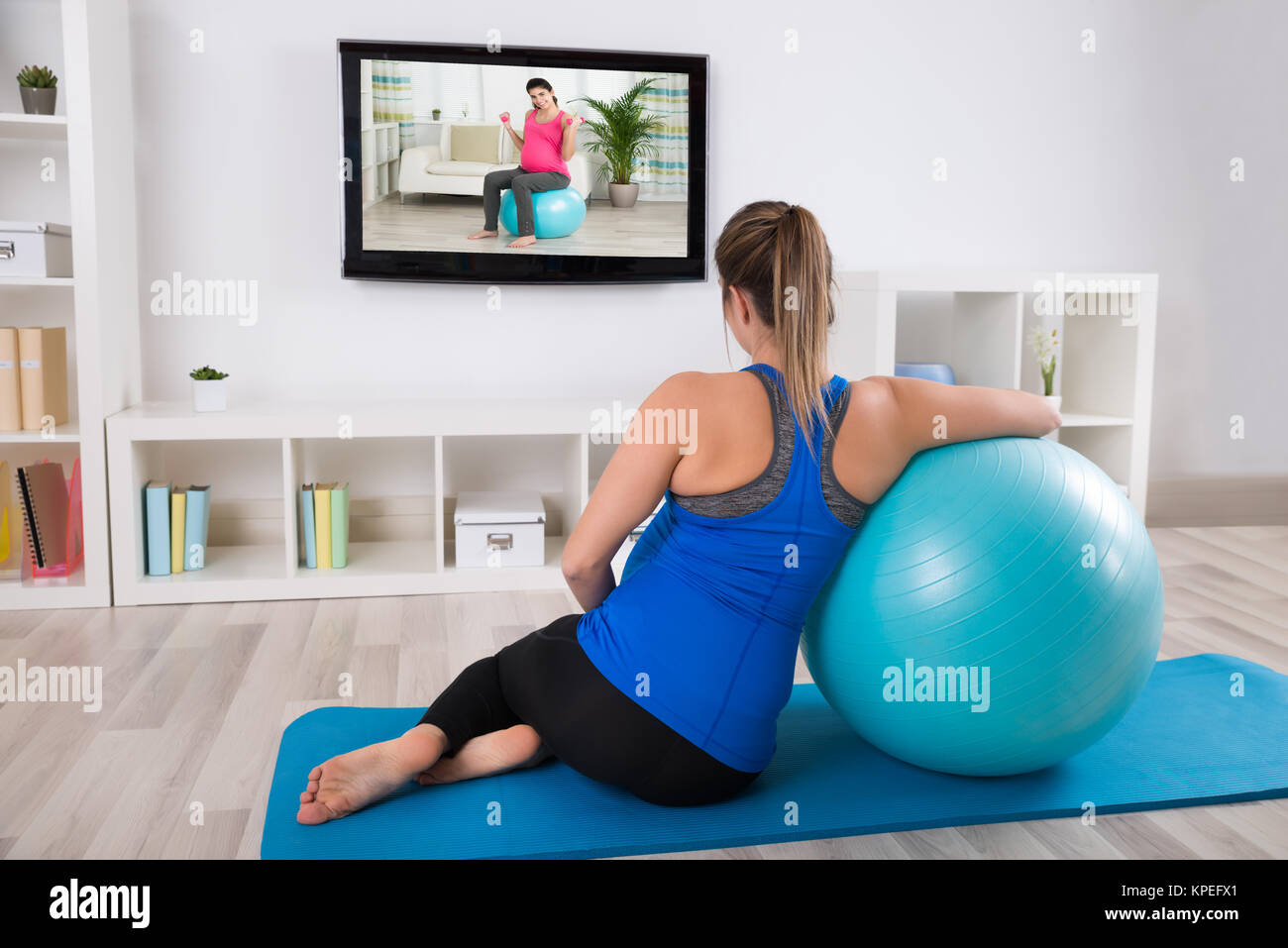 Pregnant Woman Watching Television Stock Photo - Alamy
