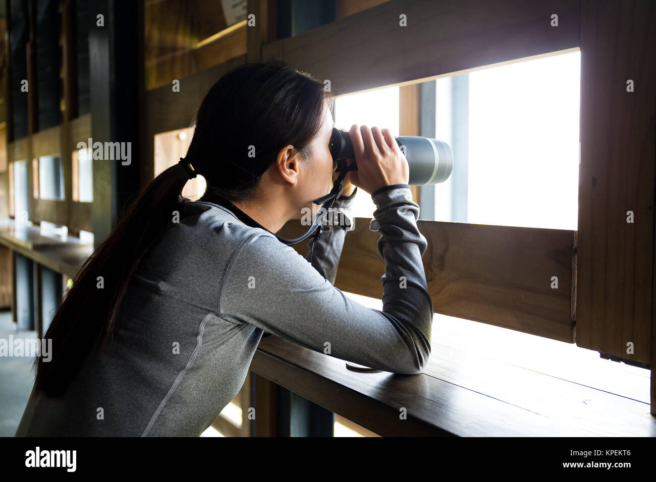 Woman use binocular in wooden house Stock Photo Alamy