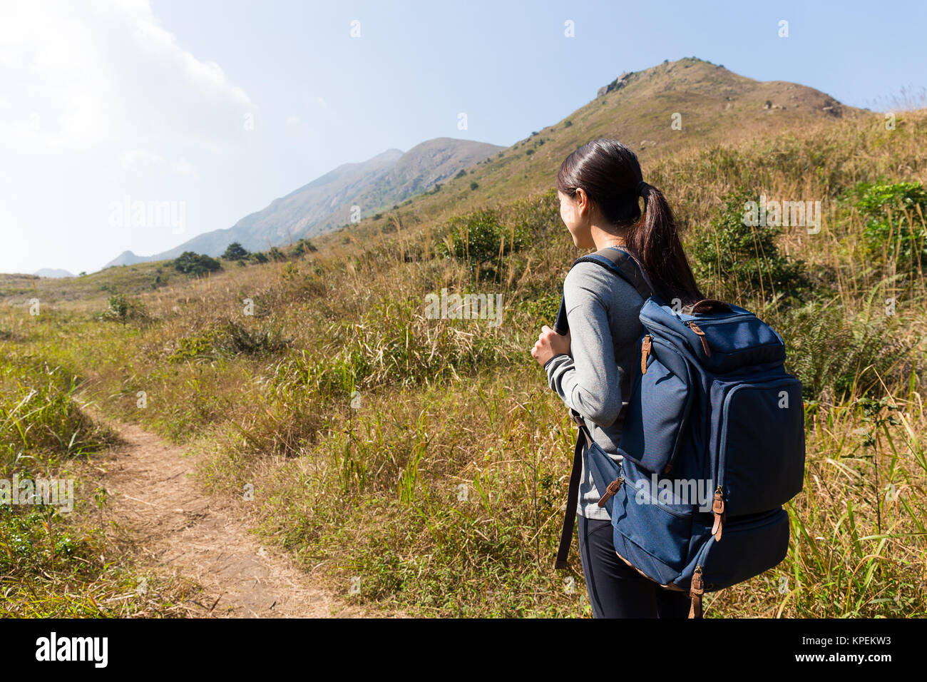 Rear view of woman go hiking Stock Photo - Alamy