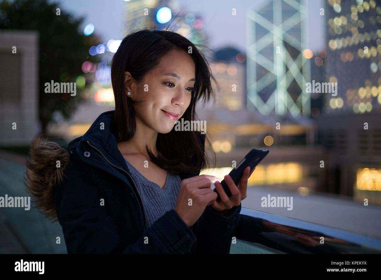 Woman use her phone in the city in Hong Kong Stock Photo - Alamy