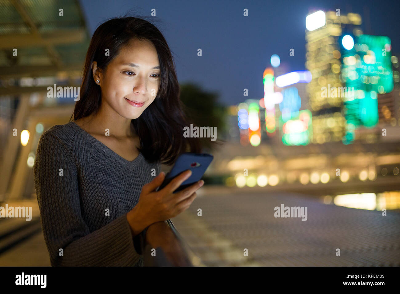 Woman look at mobile phone at night Stock Photo - Alamy