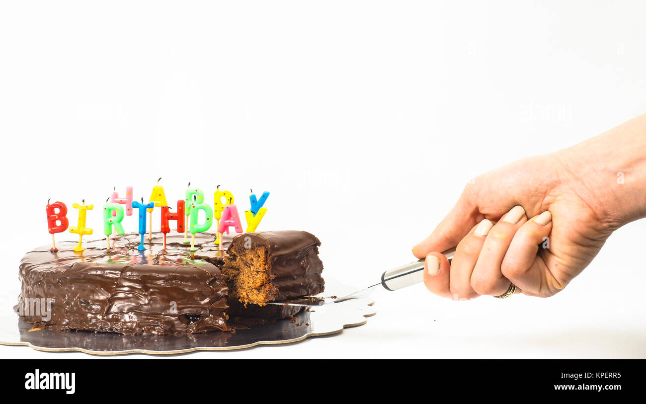 Female person serving sacher chocolate cake, birthday candles Stock Photo