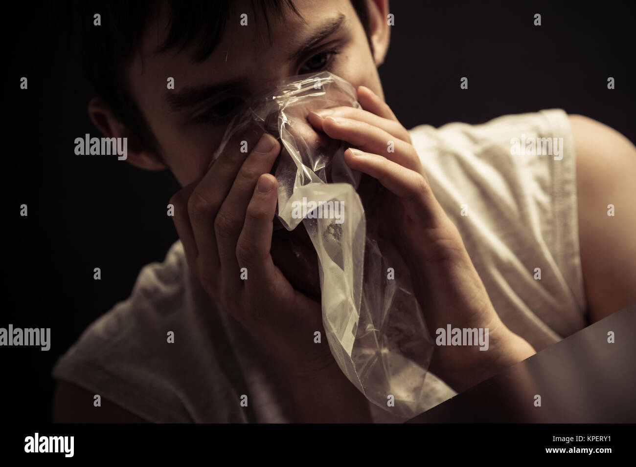 Teen inhaling narcotics from plastic bag Stock Photo Alamy