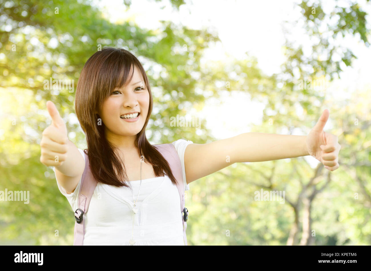 Asian college student thumb up Stock Photo - Alamy