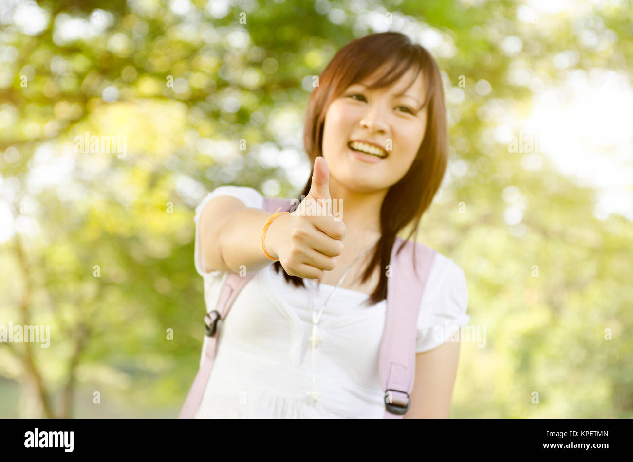 Young Asian college girl student thumb up Stock Photo - Alamy