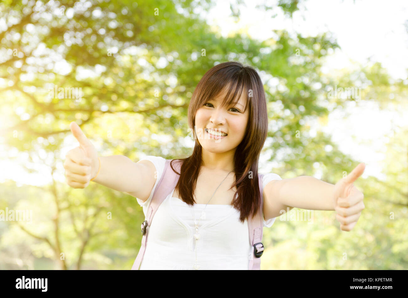 Asian college girl student thumb up Stock Photo - Alamy