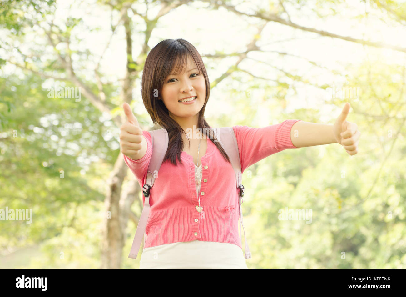 Young Asian college student showing thumb up Stock Photo - Alamy