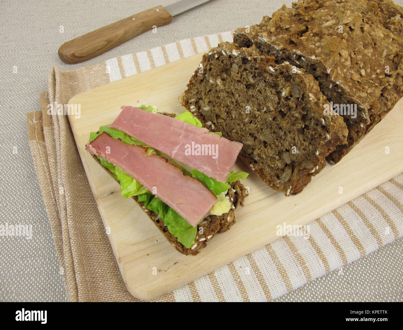 topped brown bread with smoked ham and lettuce Stock Photo