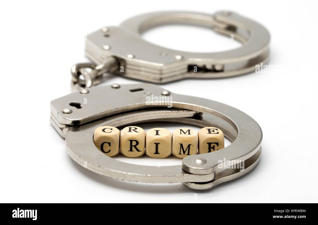 Handcuffs with word crime on wooden cubes Stock Photo