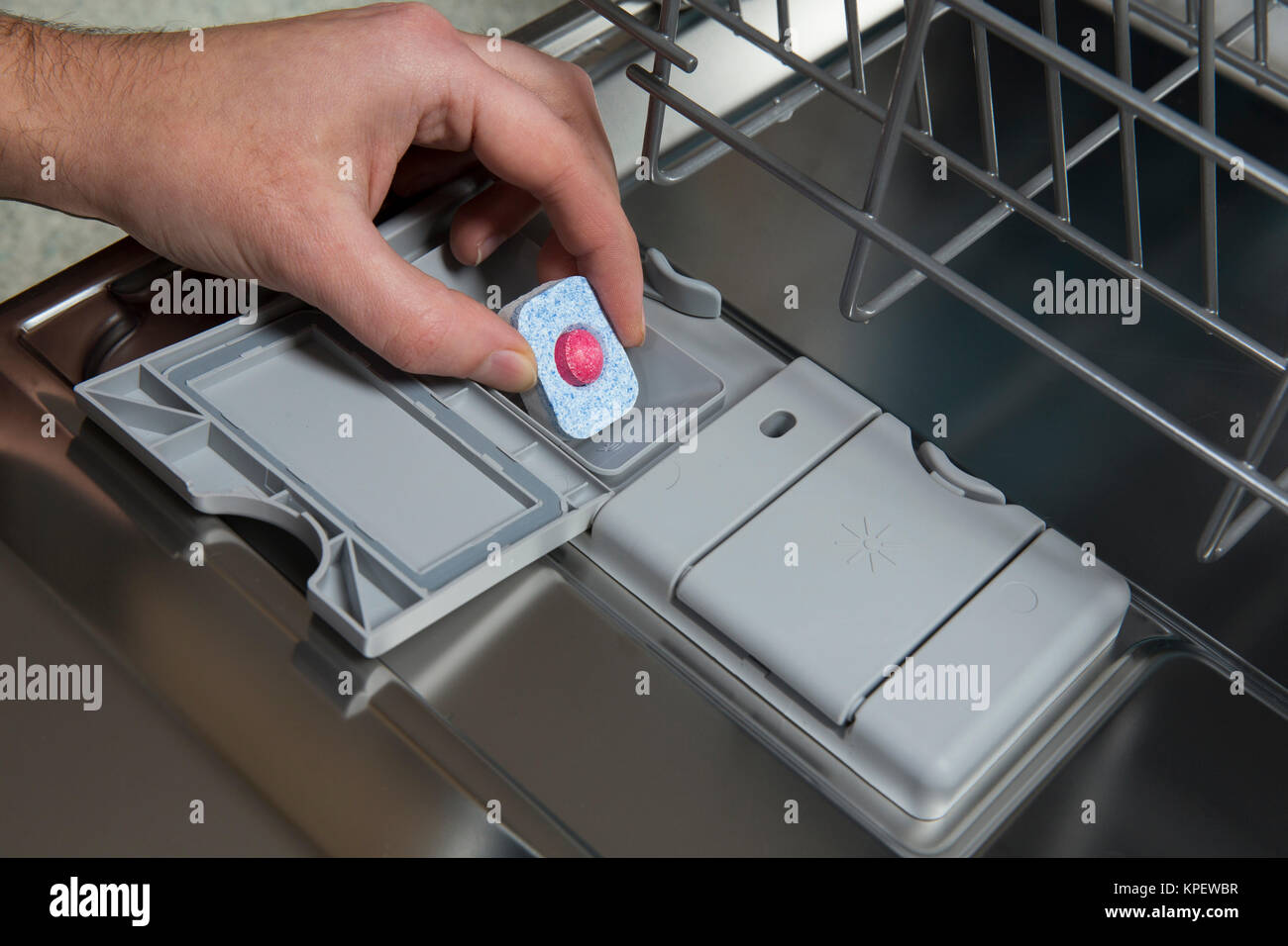 Putting tablet in dishwasher machine Stock Photo Alamy