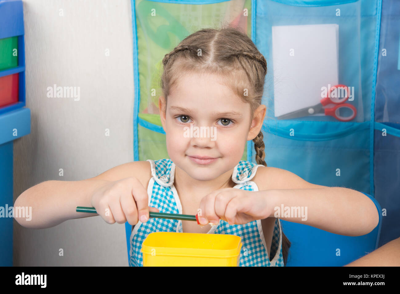 Happy five year old girl sharpens a pencil sharpener small Stock Photo -  Alamy