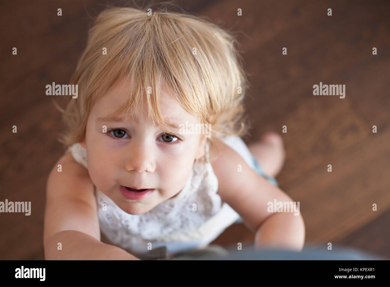 complaining baby holding leg Stock Photo Alamy